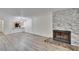 Living room showcasing a fireplace with stone accents and an open floor plan at 313 Martha Ln # 4, Oldsmar, FL 34677