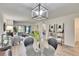 Open living space with light fixture, views of the living room, and access to the bedroom at 313 Martha Ln # 4, Oldsmar, FL 34677