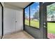 Enclosed patio with tile flooring, windows offering views of the lawn and surrounding buildings at 313 Martha Ln # 4, Oldsmar, FL 34677
