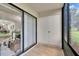 Enclosed patio featuring sliding glass doors to living space, tile flooring, and exterior views at 313 Martha Ln # 4, Oldsmar, FL 34677