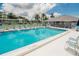 Community pool with lounge chairs and tables, perfect for relaxation at 313 Martha Ln # 4, Oldsmar, FL 34677