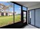 Screened-in porch showing view of well-manicured lawns and community buildings at 313 Martha Ln # 4, Oldsmar, FL 34677