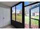 Enclosed porch with views of green lawn and community buildings at 313 Martha Ln # 4, Oldsmar, FL 34677