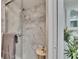 A glass enclosed shower with decorative tile and gray towel is nicely appointed at 313 Martha Ln # 4, Oldsmar, FL 34677