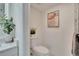 Clean bathroom with a modern toilet, tasteful artwork, and a soothing plant for added ambiance at 313 Martha Ln # 4, Oldsmar, FL 34677