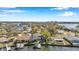 Stunning aerial view of waterfront property with private dock and boat lifts, surrounded by lush greenery and neighboring homes at 3598 10Th Ne St, St Petersburg, FL 33704
