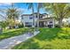 Waterfront view and seating area in this beautifully landscaped backyard with tropical trees at 3598 10Th Ne St, St Petersburg, FL 33704
