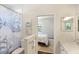 Nautical themed bathroom boasting patterned tile floors, framed ocean artwork, and a sailboat shower curtain at 3598 10Th Ne St, St Petersburg, FL 33704