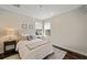 Inviting bedroom with soft lighting, two windows, neutral color palette, and cozy rug on hardwood floors at 3598 10Th Ne St, St Petersburg, FL 33704