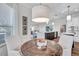 Bright breakfast nook with a wooden table, pendant lighting, and a peek into the living room for a cozy and inviting space at 3598 10Th Ne St, St Petersburg, FL 33704
