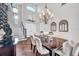 Open-concept dining room featuring hardwood floors, chandelier, staircase and ample space for entertaining guests in style at 3598 10Th Ne St, St Petersburg, FL 33704