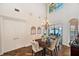 Dining room with modern chandelier, herringbone wood floors and access to the patio overlooking the water at 3598 10Th Ne St, St Petersburg, FL 33704