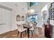 Bright dining room with hardwood floors, a chandelier, wine racks, and water views, perfect for elegant meals at 3598 10Th Ne St, St Petersburg, FL 33704