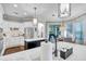 Well-lit kitchen with marble counters, stainless steel appliances, and a view into the dining area at 3598 10Th Ne St, St Petersburg, FL 33704