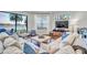 Cozy living room with a comfortable sectional couch, large windows, and views of the water at 3598 10Th Ne St, St Petersburg, FL 33704