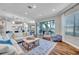 Open living area with ample seating, area rug, and sliding doors to the outdoor space at 3598 10Th Ne St, St Petersburg, FL 33704