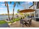 Inviting outdoor patio with dining area, waterfront views, and lush landscaping at 3598 10Th Ne St, St Petersburg, FL 33704