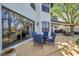 A charming blue seating area is seen on the large patio, with trees overhead at 3598 10Th Ne St, St Petersburg, FL 33704