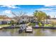 Waterfront home with a boat dock and lift, lush landscaping, and fenced yard for privacy at 3598 10Th Ne St, St Petersburg, FL 33704
