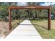 Scenic walkway into Albritton Park, framed by park signage and lush greenery at 3610 Aberdeen Gait Ct, Odessa, FL 33556