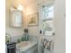 Well-lit bathroom with a modern vanity and a window, blending functionality with comfort at 375 Magnolia Rd, Venice, FL 34293