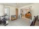 Open bonus room with tile flooring and an opening to the living room area with a dining table set at 375 Magnolia Rd, Venice, FL 34293