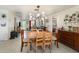 Bright dining area featuring modern lighting fixture and an open layout with views to the living room at 375 Magnolia Rd, Venice, FL 34293
