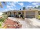 Charming single-story home with a well-manicured lawn and attached garage at 375 Magnolia Rd, Venice, FL 34293
