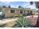 Charming single-story home with a well-manicured front yard and inviting curb appeal under a sunny sky at 375 Magnolia Rd, Venice, FL 34293