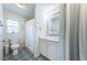 Bright bathroom features a toilet, vanity with marble countertops, patterned floors, and a shower at 3850 6Th N Ave, St Petersburg, FL 33713