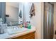 The bathroom features a single sink with a wood cabinet, a shower with curtain, and a large mirror at 3850 6Th N Ave, St Petersburg, FL 33713