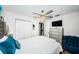 Bright bedroom showcasing a chic ceiling fan, a mirrored dresser, and closet with sliding doors at 3850 6Th N Ave, St Petersburg, FL 33713