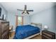 This cozy bedroom features a ceiling fan, a wooden desk, and natural light from a nearby window at 3850 6Th N Ave, St Petersburg, FL 33713