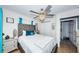 This bedroom features a large upholstered headboard, a decorative ceiling fan, and coordinated furnishings at 3850 6Th N Ave, St Petersburg, FL 33713