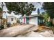 Charming blue home features a white garage door and a bright red front door at 3850 6Th N Ave, St Petersburg, FL 33713