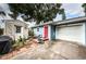 Charming blue home features a white garage door and a bright red front door at 3850 6Th N Ave, St Petersburg, FL 33713