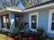 Exterior side view showing the blue paint, the window, front porch, and landscaping at 3850 6Th N Ave, St Petersburg, FL 33713