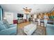 Open-concept living room with ceiling fan, and barstool seating to the kitchen at 3850 6Th N Ave, St Petersburg, FL 33713