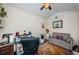This home office features a desk, a grey loveseat, ceiling fan, and bright natural lighting at 3850 6Th N Ave, St Petersburg, FL 33713