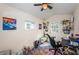This home office features a desk, a grey loveseat, ceiling fan, and bright natural lighting at 3850 6Th N Ave, St Petersburg, FL 33713