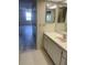 Bathroom featuring vanity with sink, mirror, and view into adjacent bedroom at 400 Island Way # 908, Clearwater Beach, FL 33767
