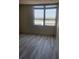Bedroom with light wood floors, large window showcasing city views, and neutral colored walls at 400 Island Way # 908, Clearwater Beach, FL 33767