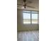 Bedroom with light wood floors, ceiling fan, and large window showcasing city views at 400 Island Way # 908, Clearwater Beach, FL 33767
