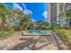 Community hot tub surrounded by stone pavers and manicured landscaping at 400 Island Way # 908, Clearwater Beach, FL 33767
