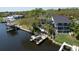 Stunning waterfront home with a large deck, private dock, and beautiful landscaping with lush trees at 4035 N River View Ave, Tampa, FL 33607