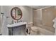 Well-lit bathroom features a vanity with marble countertop, decorative mirror and glass enclosed shower at 4035 N River View Ave, Tampa, FL 33607
