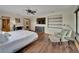 Spacious bedroom boasts modern decor, a ceiling fan, hardwood floors, and a comfortable seating area at 4035 N River View Ave, Tampa, FL 33607