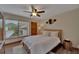 Cozy bedroom featuring a queen bed, ceiling fan, and wood-look flooring at 4035 N River View Ave, Tampa, FL 33607