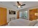 Bedroom features a queen-sized bed, fan, and built-in wardrobe at 4035 N River View Ave, Tampa, FL 33607