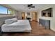 Comfortable bedroom with large bed, dark dresser, ceiling fan, and hardwood floors at 4035 N River View Ave, Tampa, FL 33607